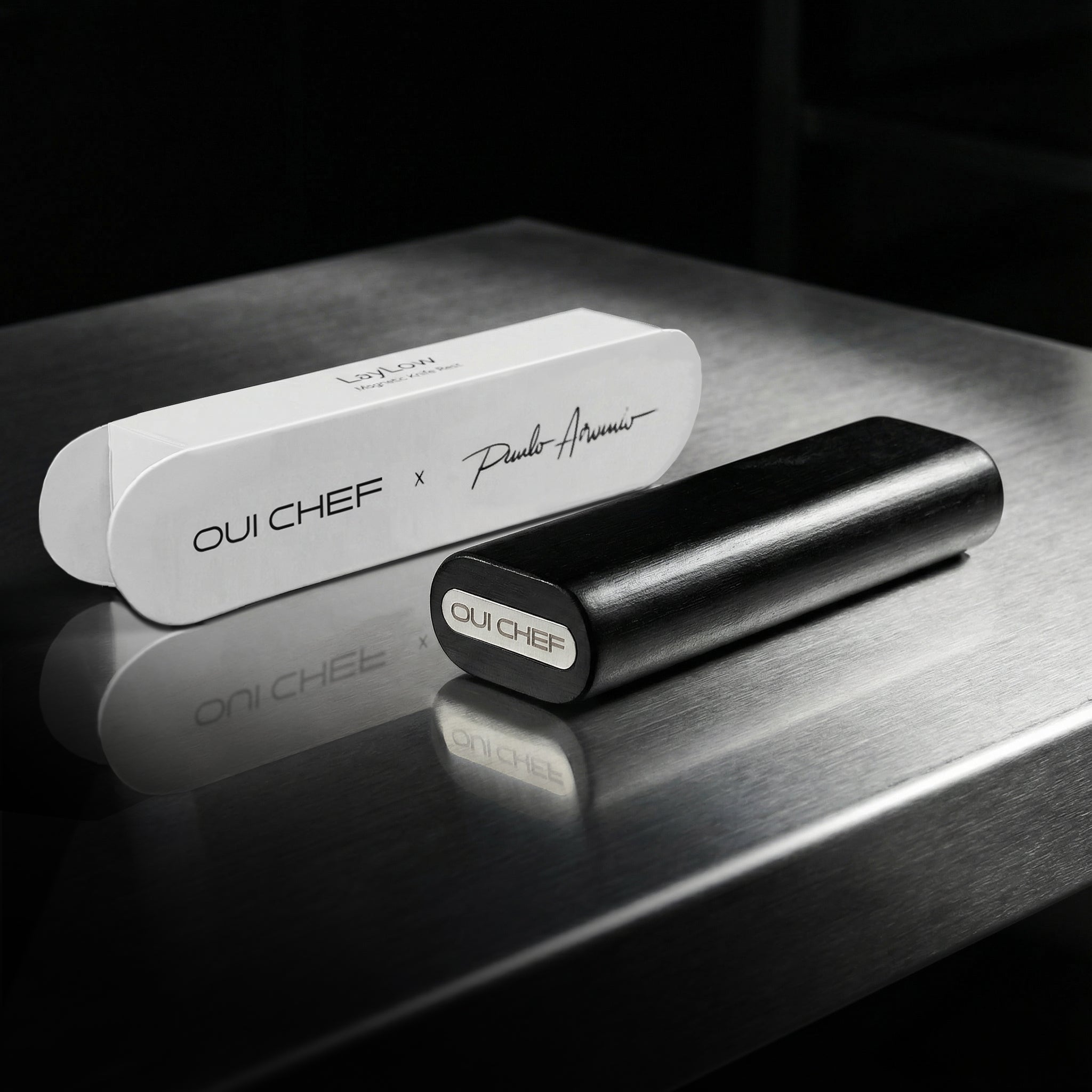 Modular laylow knife rest sitting on a steel kitchen worktop alongside the product packaging.