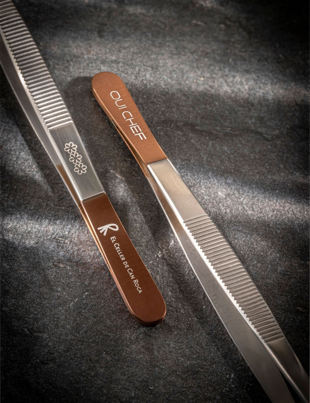 Copper top tweezers with "El Celler de Can Roca" logo and 3 michelin stars 
engraved on one side and the "Oui Chef" logo engraved on the other side.
